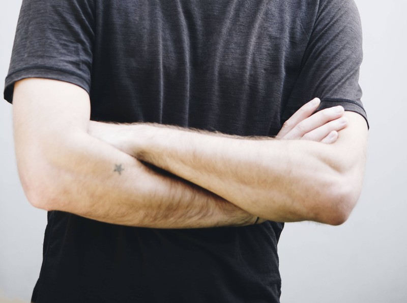 Sternchen-Tattoo auf dem Arm eines Mannes