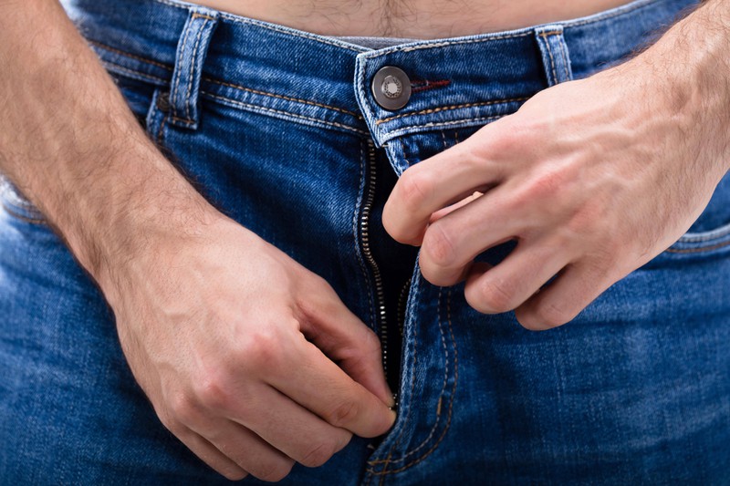 Mann macht sich die Hose auf